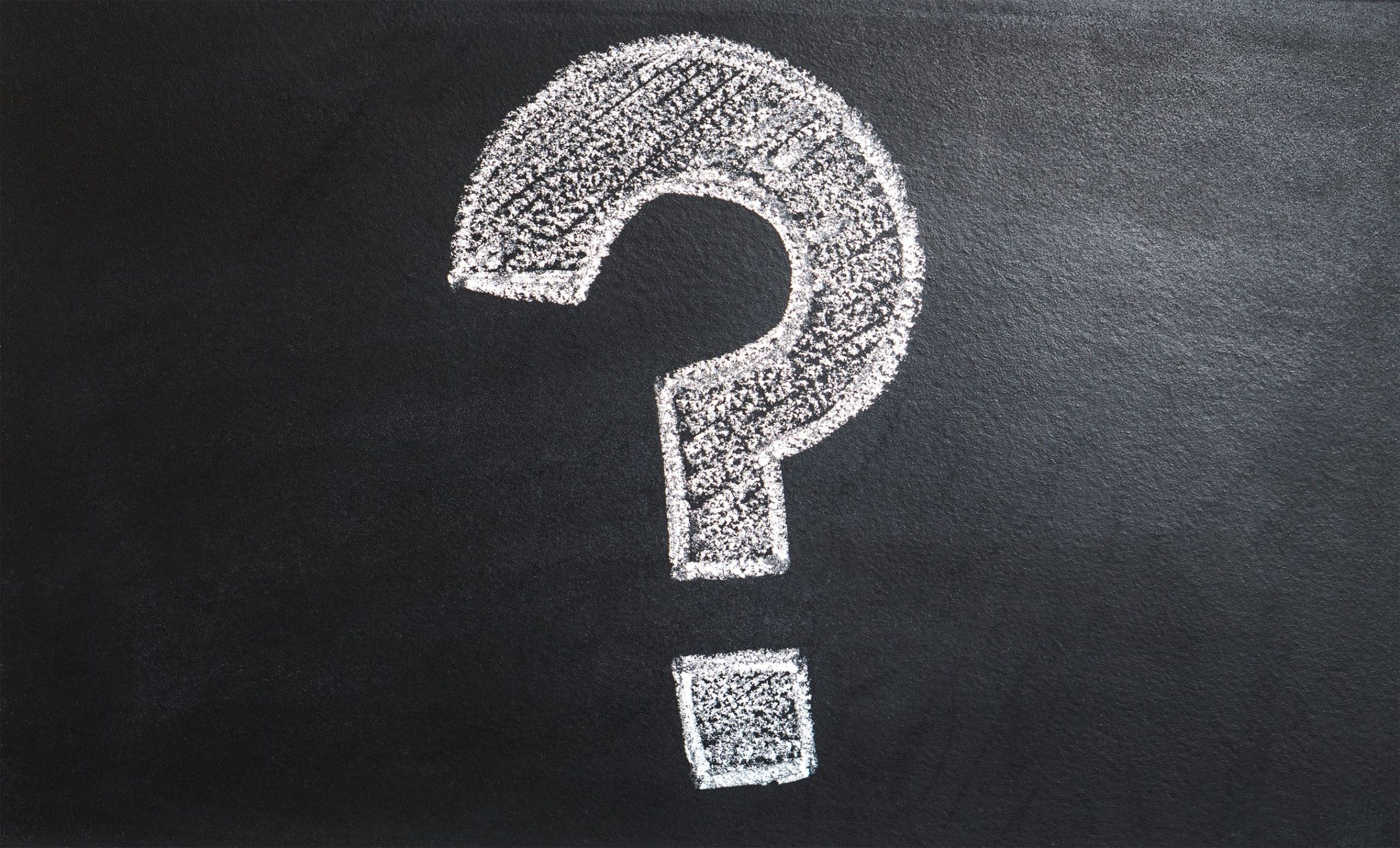 question mark drawn on a chalkboard, ideal for problem-solving contexts.